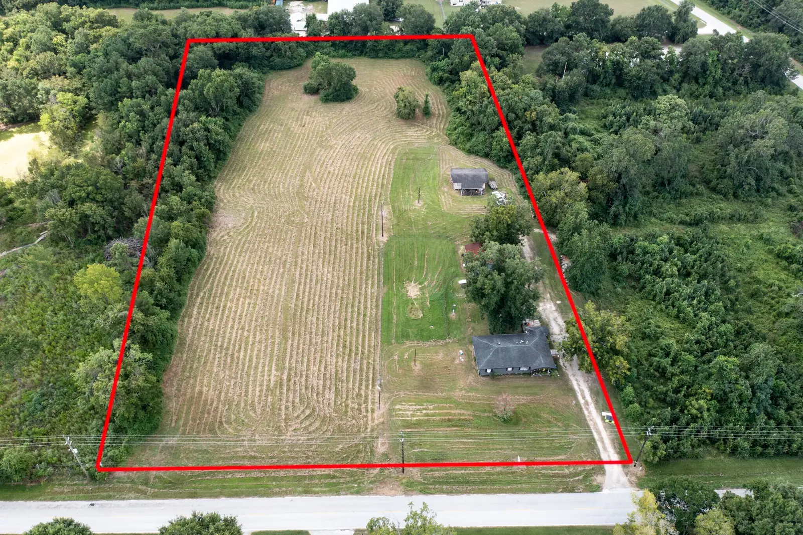 Aerial view of the 5-acre site at 14615 Medical Complex Drive, Tomball, with the property boundary outlined in red