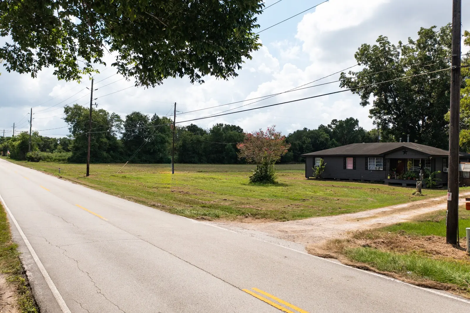Ground-level view of the Medical Complex Drive frontage, with the existing single-storey house on the site